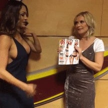 Nikki flaunts her massive titties while the interviewer hides her small chest booty a magazine.