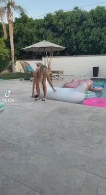 Blondy trying to sit on inflatable swan and flashing panties